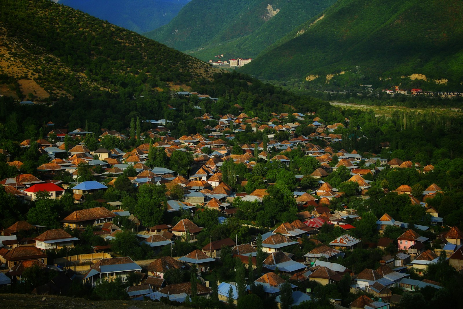 Pueblo de techos rojos en un valle verde rodeado de montañas en el norte de Azerbaiyán